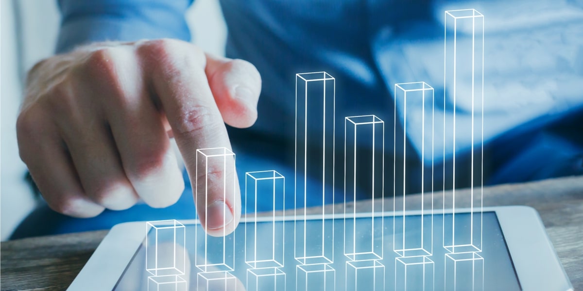 Hand interacting with a 3D holographic bar chart on a tablet screen