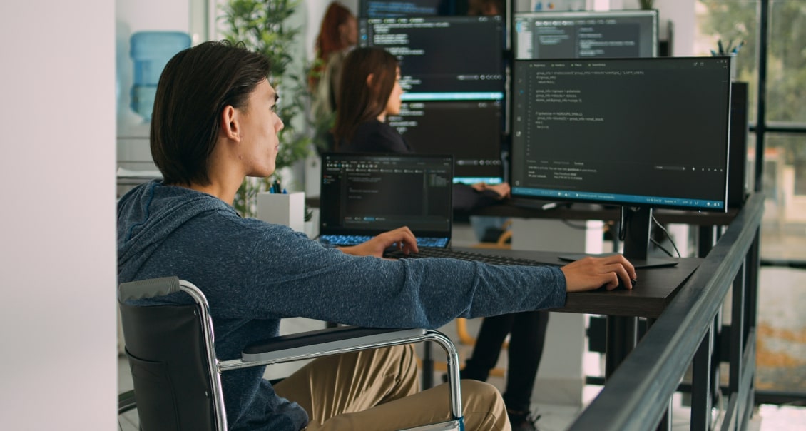 Developers coding at desks with multiple monitors in a modern office, building MVP