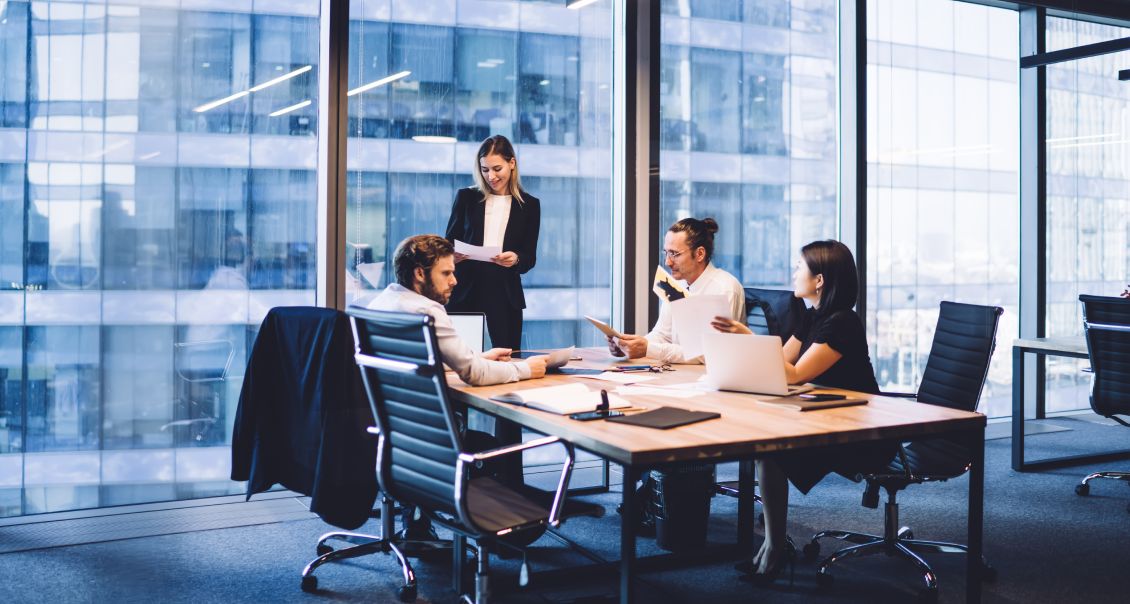 ERP project team reviews implementation progress in a high-rise corporate office setting