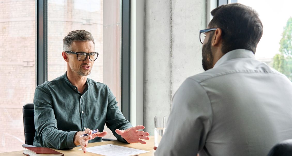 Manager and developer discuss ERP module requirements and system performance improvements
