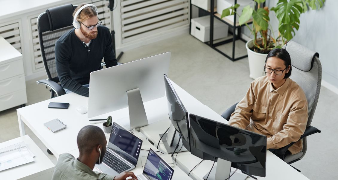ERP software developers work on system coding and integrations at multi-monitor workstations