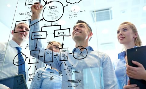 Sales team reviews analytics and customer data visualizations through ERP sales dashboard