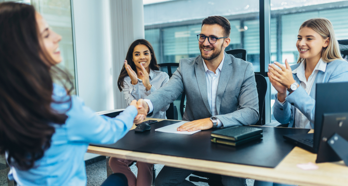 Business executives shaking hands, signifying successful enterprise software partnership