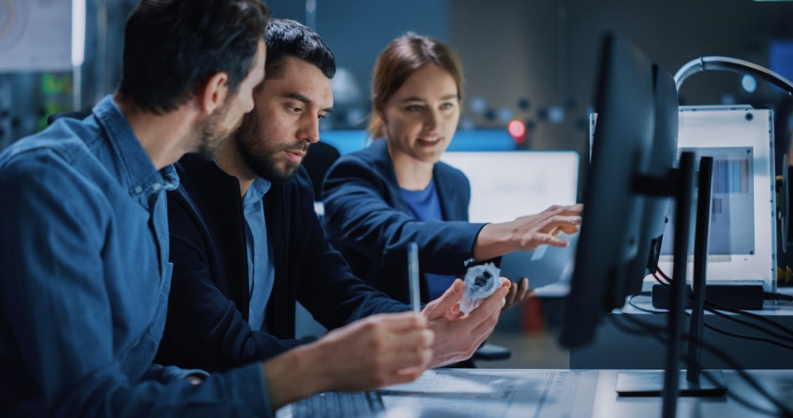 Team of professionals collaborating on a tech project, analyzing data and prototypes