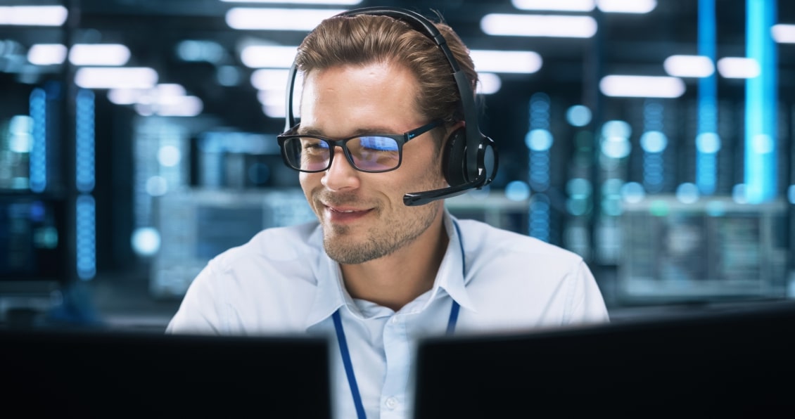 IT support specialist wearing a headset, assisting with cloud solutions in a data center