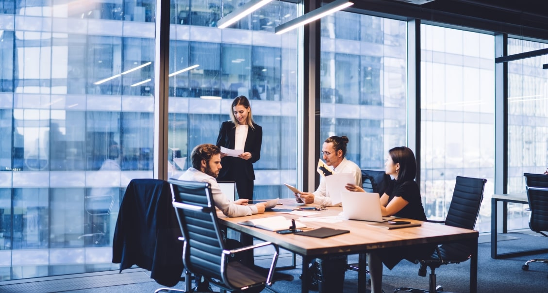 Team of IT consultants discussing software development strategy in a modern office