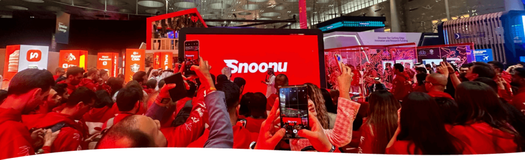Crowd gathering at Snoonu event, capturing moments on phones