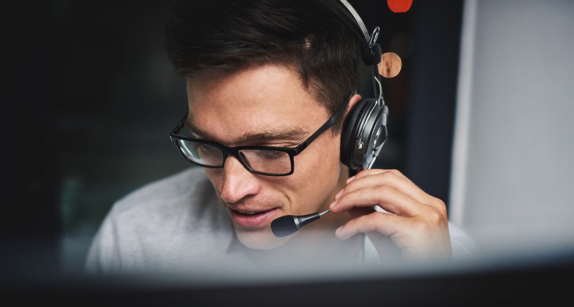 Support agent wearing headset, engaging with customers via AI-powered communication platform.