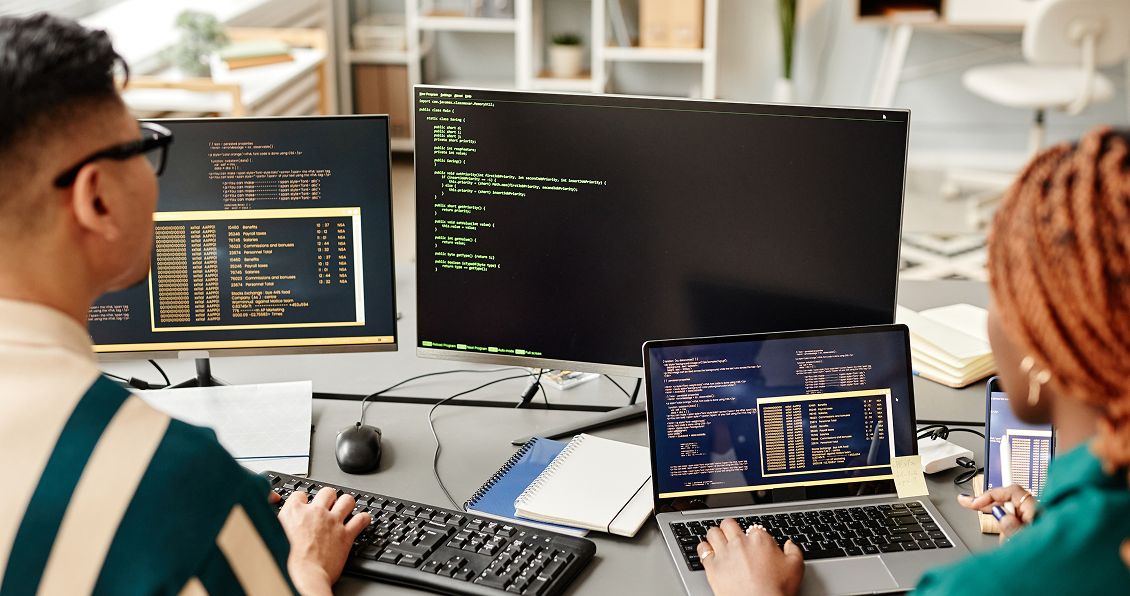 PHP developers writing code on their laptops