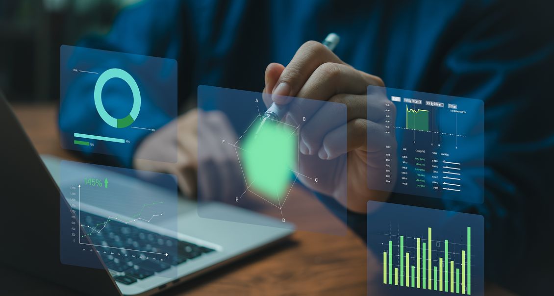 Data analyst interacting with a futuristic digital dashboard displaying charts and graphs