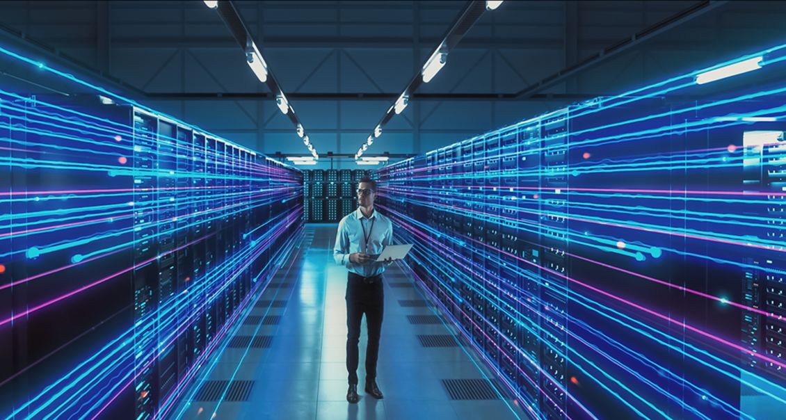 IT specialist monitoring data center servers with glowing digital connections