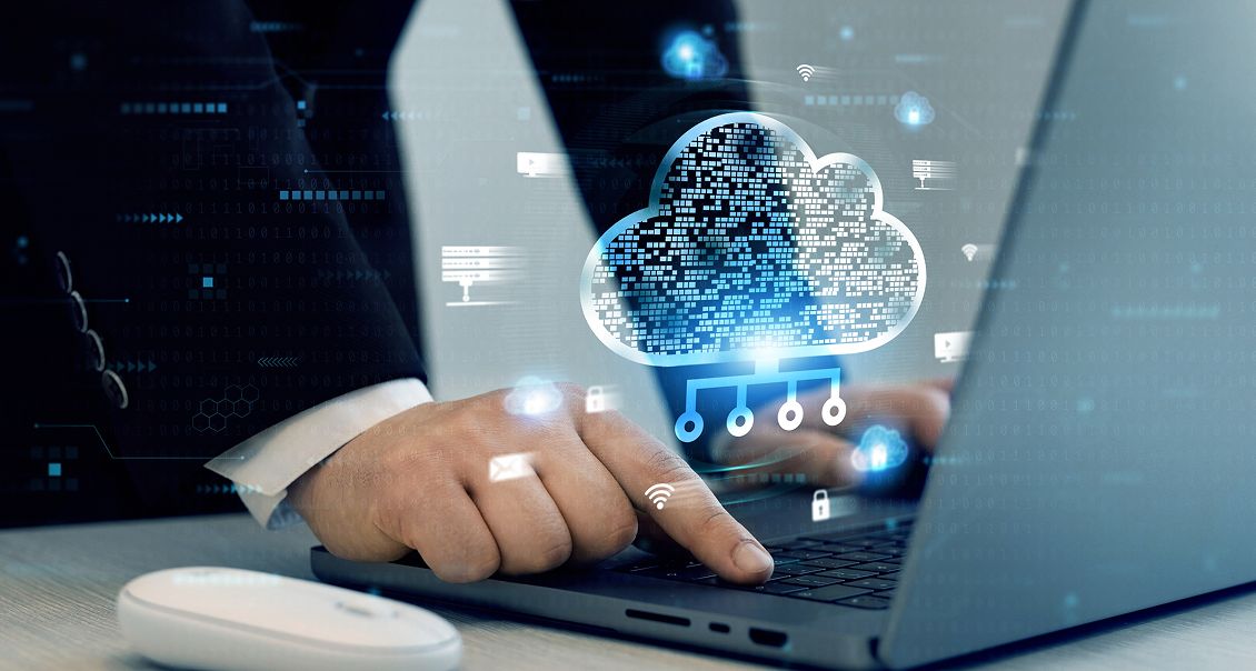 Person using laptop with cloud computing visualization