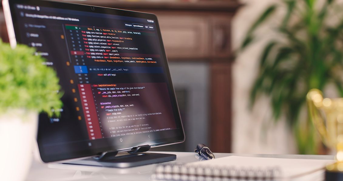 Computer monitor in a modern workspace displaying lines of Java code