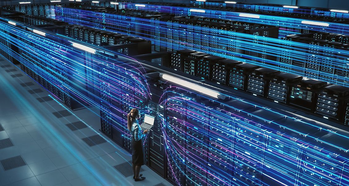 IT professional analyzing high-tech data servers with glowing digital network connections