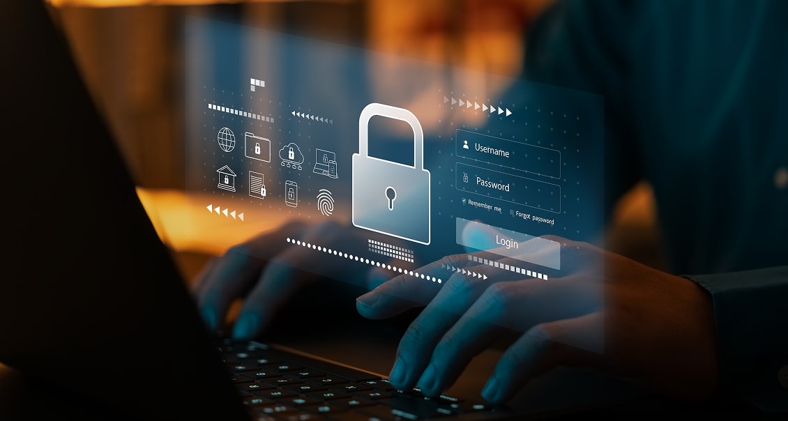 Hands typing on a laptop keyboard. A transparent digital overlay shows a large padlock icon, login fields for username and password, and security-related symbols, representing data protection and online cybersecurity.