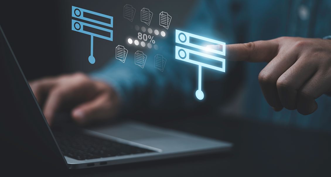 A person uses a laptop while touching a virtual screen with glowing digital icons, including lists, cloud upload/download symbols, documents, and an 80% progress indicator, suggesting data transfer or cloud computing activity.