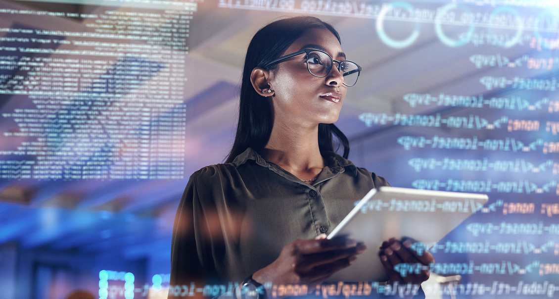 A woman with glasses holds a tablet and looks thoughtfully at floating digital code and data on transparent screens, suggesting she is working with advanced technology or programming in a modern, high-tech environment.