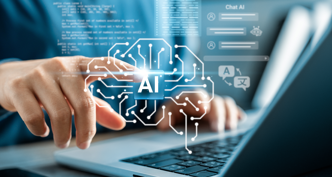 A person’s hand points at a glowing AI icon on a digital network overlay above a laptop keyboard. Futuristic data charts, chat bubbles, and circuit lines suggest artificial intelligence technology and data processing.