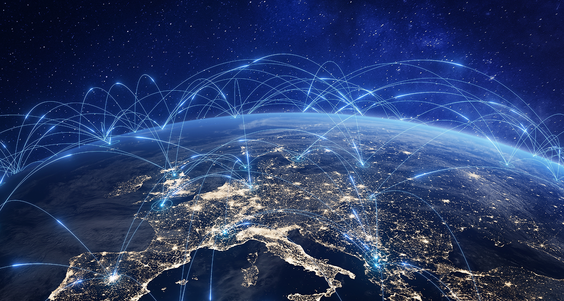 A view of Earth from space showing Europe, with illuminated city lights. Blue arcs and lines connect various points across the continent, symbolizing global communication or digital connectivity. The dark sky is filled with stars.