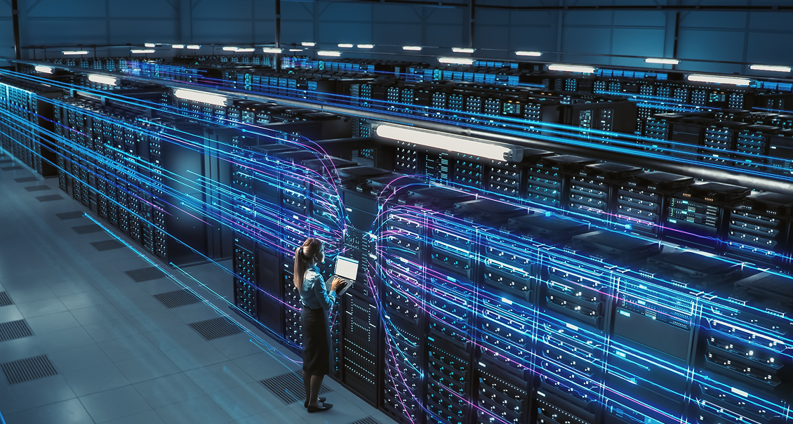 A woman stands in a large server room, holding a laptop and inspecting black server racks. Blue and purple digital light trails, representing data flow, swirl through the air around the servers, highlighting the concept of advanced data technology and connectivity.