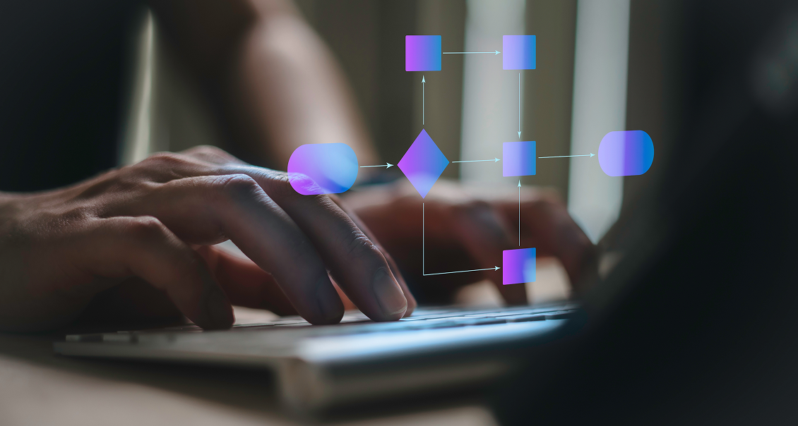 Hands typing on a laptop keyboard with a semi-transparent digital flowchart overlay, featuring connected rectangles and a diamond shape, symbolizing technology, data processing, or workflow automation. The background is softly blurred.