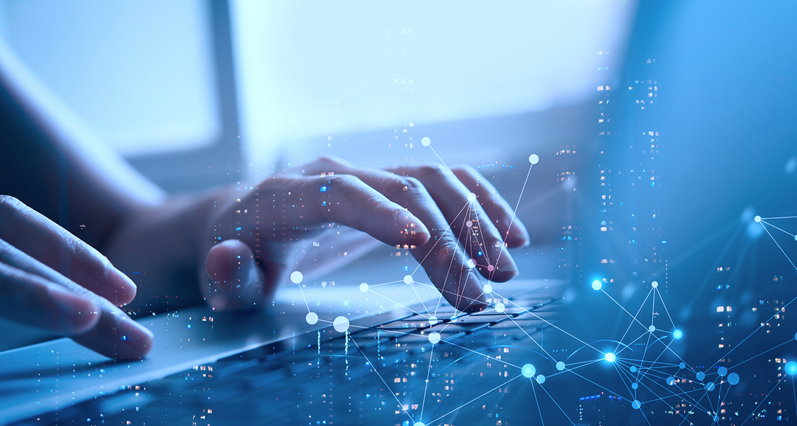 Close-up of hands typing on a laptop keyboard, with a blue overlay featuring digital network lines and glowing nodes, symbolizing technology, connectivity, and data exchange in a modern digital environment.