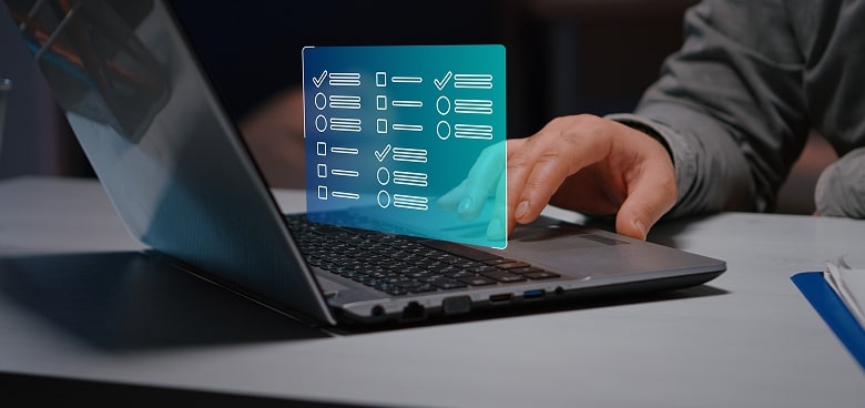 A person uses a laptop with one hand on the keyboard. A digital checklist with checkmarks and bullet points appears holographically above the keyboard, representing a virtual or online task list. The setting appears to be an office or workspace.