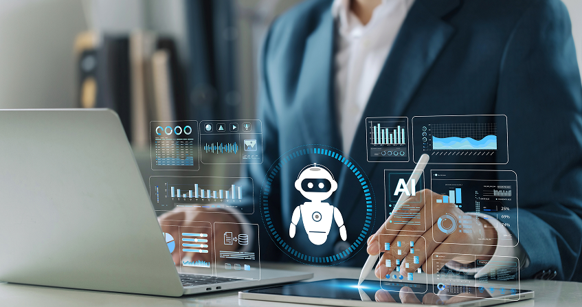 A person in a suit works on a laptop and tablet at a desk. Digital screens with charts, graphs, and an AI robot icon are overlaid, illustrating concepts of artificial intelligence, data analysis, and technology.