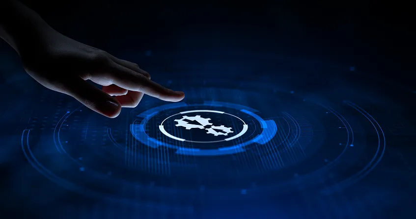 A hand reaches toward a glowing digital gear icon on a dark blue, futuristic interface. Circular patterns and technological elements surround the icon, suggesting automation, innovation, or settings in a high-tech environment.