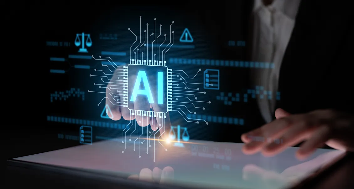 A person’s hand interacts with a touchscreen displaying a glowing, digital AI microchip graphic. Circuit-like lines radiate from the chip, with icons of scales and warnings in the background, symbolizing artificial intelligence technology.