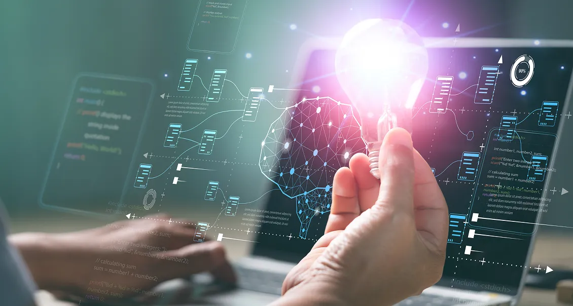 A person holds a glowing lightbulb in front of a laptop with a digital brain and data flow diagrams overlayed, symbolizing innovation, artificial intelligence, and data science technology. The scene is futuristic and high-tech.