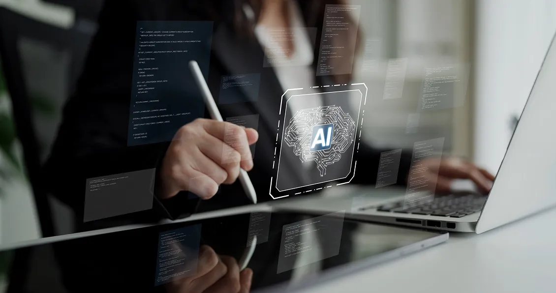 A person in business attire uses a stylus on a tablet near a laptop. Floating digital screens and a central glowing AI icon with a circuit brain illustrate artificial intelligence, technology, and data analysis concepts in a modern workspace.