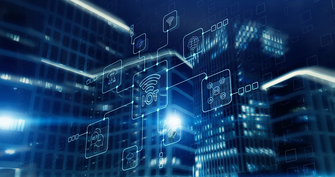 Digital illustration of a cityscape at night with tall, glass buildings. Overlay of glowing blue icons, including IoT, cloud, Wi-Fi, and security symbols, are interconnected, representing smart city and internet of things technology integration.
