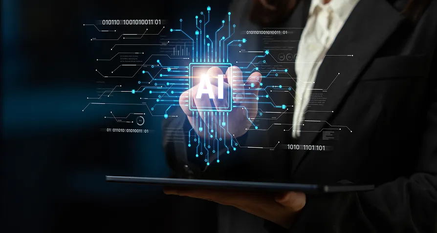 A person in a suit touches a glowing floating AI icon surrounded by digital circuit lines, representing artificial intelligence technology, while holding a tablet. The background is dark, emphasizing the futuristic and high-tech theme.