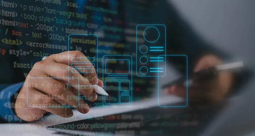 A person holds a stylus and uses a tablet, with their other hand on a keyboard. Transparent UI wireframe icons and code are overlaid, symbolizing web or app design and development. The scene is focused on digital interface creation.