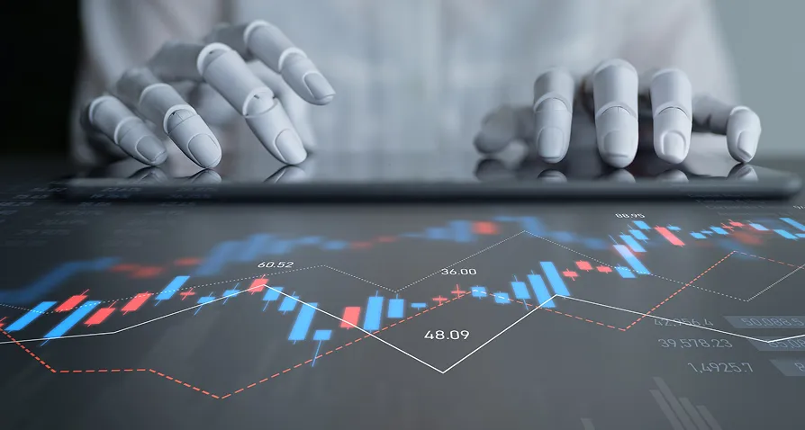 A pair of robotic hands is typing on a keyboard or tablet, with a transparent overlay of a financial stock chart featuring blue and red candlesticks, fluctuating lines, and numerical data, symbolizing AIs role in finance and data analysis.