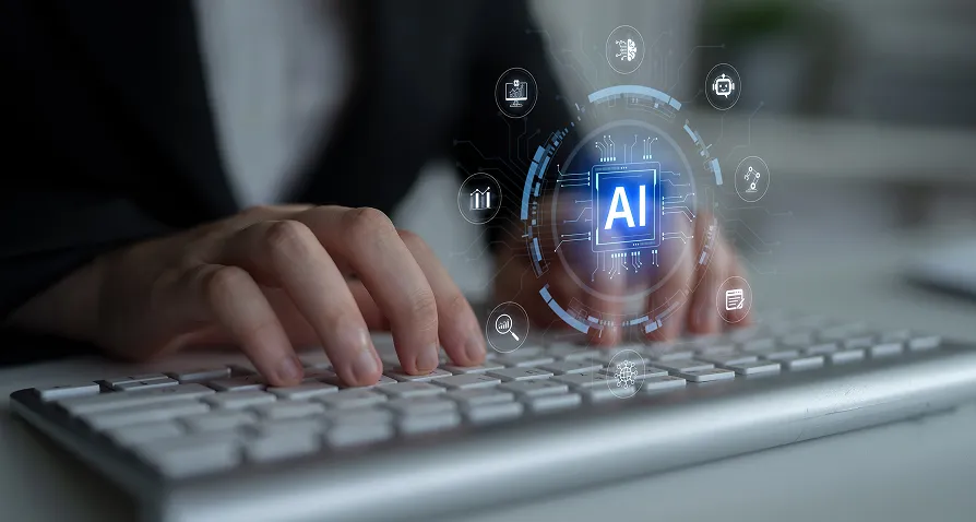 A person in business attire types on a white computer keyboard. Overlaid graphics show a digital AI icon in the center, surrounded by futuristic technology and data symbols, representing artificial intelligence and innovation.