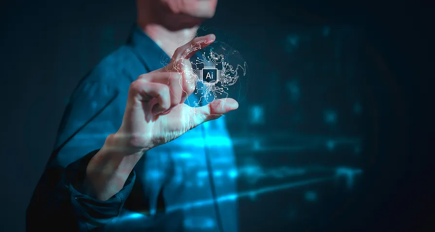 A person in a blue shirt holds a translucent disc with an AI logo and digital circuit patterns, symbolizing artificial intelligence. The background is dark and futuristic, with glowing blue lines and tech-inspired graphics.