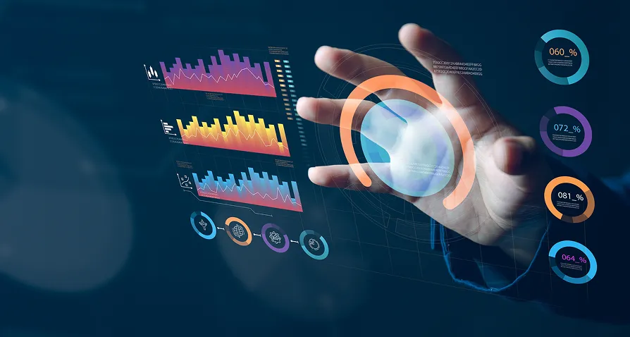 A hand interacts with a transparent virtual screen displaying colorful data charts, bar graphs, circular progress indicators, and analytics icons, representing digital data analysis and futuristic technology. The background is dark blue.